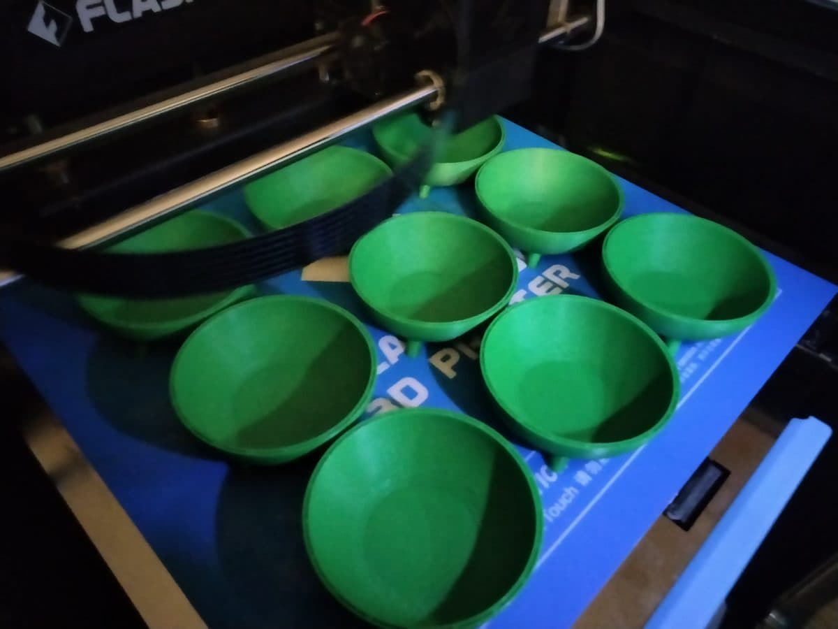 Green printed bowls on a printer build plate