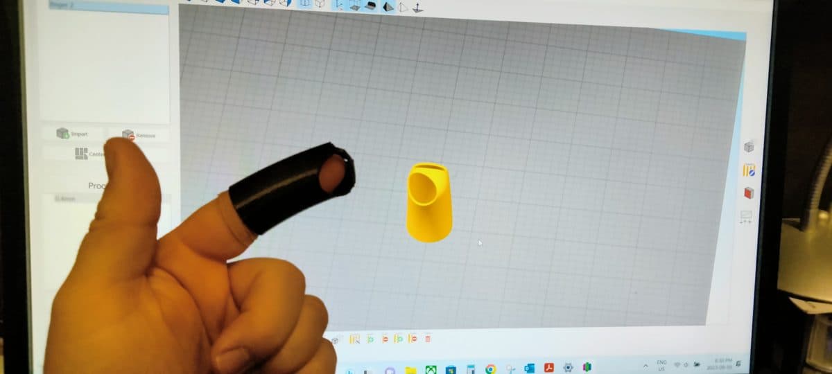 CAD model on screen next to the printed part