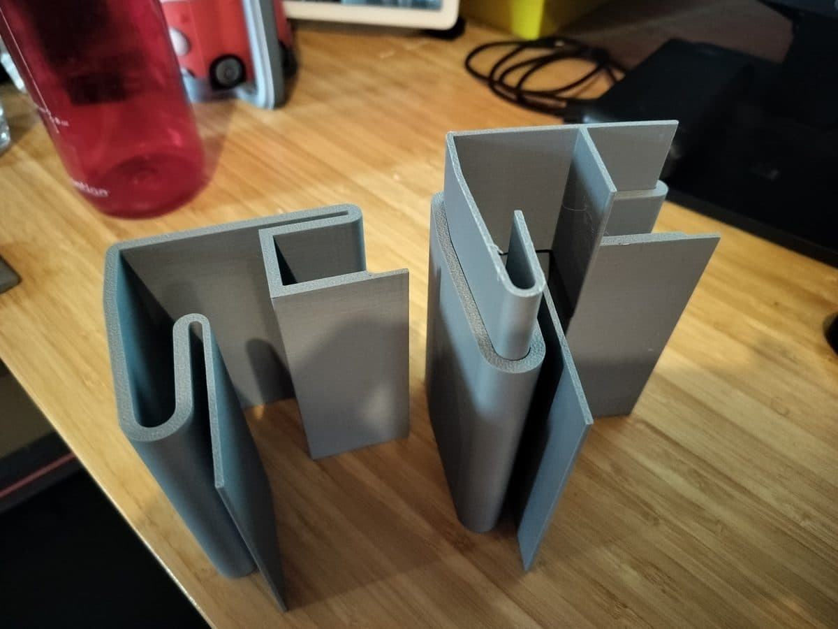 Grey printed brackets on a workbench